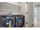 Convenient laundry room features modern washer and dryer set and storage shelf at 509 Sherron Rd # 11, Durham, NC 27703