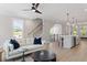 Open-concept living room with hardwood floors, lots of natural light, and modern ceiling fan at 509 Sherron Rd # 11, Durham, NC 27703