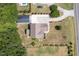 Property with a swimming pool, a large driveway and carport on a large lot with trees at 5180 Old Powell Rd, Holly Springs, NC 27540