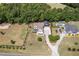 Expansive property featuring well-kept landscaping, mature trees, inviting pool, and convenient carport at 5180 Old Powell Rd, Holly Springs, NC 27540