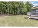 Large backyard with mature trees and a screened-in porch at 5180 Old Powell Rd, Holly Springs, NC 27540