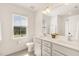 Bright bathroom with double sink vanity, large mirror, and window, and a separate shower at 5180 Old Powell Rd, Holly Springs, NC 27540
