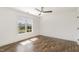 Bright bedroom with hardwood floors, white walls and trim, large window with natural light at 5180 Old Powell Rd, Holly Springs, NC 27540