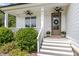 Charming front porch with white columns, stairs, and the house number 5180, inviting guests to enter this lovely home at 5180 Old Powell Rd, Holly Springs, NC 27540