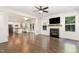 Cozy living room boasts a fireplace with shiplap accent wall and large windows for natural light at 5180 Old Powell Rd, Holly Springs, NC 27540