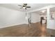 Bright living room features hardwood floors, ceiling fan, and opens to the kitchen and staircase at 5180 Old Powell Rd, Holly Springs, NC 27540