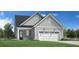 Charming home featuring a two-car garage, gray siding, black front door, and attractive landscaping at 5228 Bowes Meadow Ct # 15, Raleigh, NC 27610