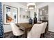 The dining room has a wooden table with seating, decor, and a view of the entryway and kitchen at 55 E American Marigold Dr # 36, Benson, NC 27504