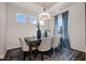 Well-lit dining room featuring a modern chandelier, decor, blue curtains, and four windows at 55 E American Marigold Dr # 36, Benson, NC 27504