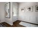 Inviting entryway boasts wood-look floors, wainscoting, a glass-paned door, and decorative wall art at 55 E American Marigold Dr # 36, Benson, NC 27504