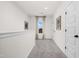 Upstairs hallway featuring carpeted floors, neutral walls, and a window for natural light at 55 E American Marigold Dr # 36, Benson, NC 27504