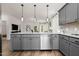 Contemporary kitchen with gray cabinetry, stainless steel appliances, granite countertops, and decorative pendant lighting at 55 E American Marigold Dr # 36, Benson, NC 27504