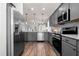 Stylish kitchen featuring gray cabinets, stainless steel appliances, granite countertops, and wood-look flooring at 55 E American Marigold Dr # 36, Benson, NC 27504