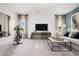 Bright living room featuring neutral walls, large TV, and furniture at 55 E American Marigold Dr # 36, Benson, NC 27504