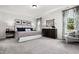 Bright main bedroom with carpet floors, large windows and a neutral color palette at 55 E American Marigold Dr # 36, Benson, NC 27504