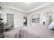 Bright and neutral main bedroom featuring plush carpet, white trim, and doors leading to the closet and bathroom at 55 E American Marigold Dr # 36, Benson, NC 27504