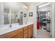 Bathroom featuring double vanity with walk-in closet and ample storage space at 59 Long Grass Dr, Smithfield, NC 27577