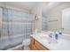 A well-lit bathroom features a shower with a blue curtain and a modern vanity with a large mirror at 59 Long Grass Dr, Smithfield, NC 27577