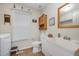 Cozy bathroom with ample natural light, featuring a utility sink, toilet, and a decorative wooden cabinet at 59 Long Grass Dr, Smithfield, NC 27577