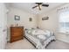 Comfortable bedroom features a bed with a quilt, wooden dresser, and ceiling fan at 59 Long Grass Dr, Smithfield, NC 27577