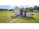 Shed with ample storage space, a small porch, and a well-kept lawn in a fenced-in backyard at 59 Long Grass Dr, Smithfield, NC 27577
