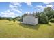 Well-kept shed in a spacious backyard with a lush green lawn and mature trees at 59 Long Grass Dr, Smithfield, NC 27577