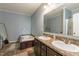 Spacious bathroom featuring dual sinks, a soaking tub, and neutral tile flooring at 5912 Mt Zion Rd, Snow Camp, NC 27349