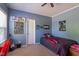 Bedroom featuring blue walls, fan, and bed with video game themed bedding at 5912 Mt Zion Rd, Snow Camp, NC 27349