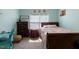 Bright bedroom featuring a full-sized bed, dresser, study area, and blue walls at 5912 Mt Zion Rd, Snow Camp, NC 27349
