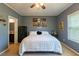 Cozy bedroom featuring a plush white bedspread, personal decorations, and a neutral color scheme at 5912 Mt Zion Rd, Snow Camp, NC 27349