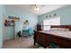 Bright bedroom featuring a full-sized bed, study area, and blue walls at 5912 Mt Zion Rd, Snow Camp, NC 27349