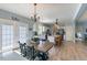 Bright dining area with a large wooden table and access to a kitchen with white cabinets and an island at 5912 Mt Zion Rd, Snow Camp, NC 27349