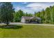 Charming one-story home features a welcoming front porch with lovely green lawn at 5912 Mt Zion Rd, Snow Camp, NC 27349