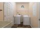 Practical laundry room with utility sink, washer, dryer, and ample storage space at 5912 Mt Zion Rd, Snow Camp, NC 27349