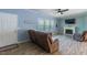 Cozy living room with fireplace, ceiling fan, luxury vinyl floors, and comfortable recliner seating at 5912 Mt Zion Rd, Snow Camp, NC 27349