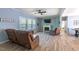 Bright living room with fireplace, ceiling fan, vinyl floors, and comfortable recliner seating at 5912 Mt Zion Rd, Snow Camp, NC 27349