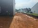 New home backyard showing lot grading in preparation for sod installation at 6828 Galloway Dr, Middlesex, NC 27557