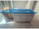 Newly installed kitchen island featuring white cabinets and a countertop covered in protective blue film at 6828 Galloway Dr, Middlesex, NC 27557