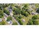 An aerial view presents a cozy home with a spacious backyard, neighbored by similar residential properties and green spaces at 701 Veterans Dr, Elon, NC 27244