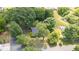 Aerial view of a home nestled among mature trees in a quiet, residential neighborhood at 701 Veterans Dr, Elon, NC 27244