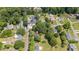 An aerial view shows a charming home nestled among mature trees, with a glimpse of nearby neighborhood streets at 701 Veterans Dr, Elon, NC 27244