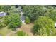 Aerial view of property featuring mature trees and a well-maintained lawn at 701 Veterans Dr, Elon, NC 27244