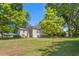 Expansive grassy backyard surrounded by mature trees, offering a private and serene outdoor space at 701 Veterans Dr, Elon, NC 27244