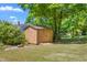 Backyard featuring a convenient storage shed and ample green space, offering practical functionality at 701 Veterans Dr, Elon, NC 27244