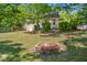 An inviting backyard featuring a charming fire pit and lush greenery, perfect for outdoor entertaining at 701 Veterans Dr, Elon, NC 27244