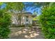 Backyard patio area featuring a table with lush trees and shade at 701 Veterans Dr, Elon, NC 27244