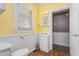 Bright bathroom with wainscoting, a single vanity, and a well-lit mirror at 701 Veterans Dr, Elon, NC 27244