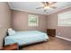 Cozy bedroom with a bed, ceiling fan, a side table, and carpet at 701 Veterans Dr, Elon, NC 27244