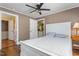 Comfortable bedroom with view to kitchen, wood floors, and a ceiling fan at 701 Veterans Dr, Elon, NC 27244