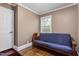 Cozy bedroom with hardwood floors, natural light, and a comfortable futon at 701 Veterans Dr, Elon, NC 27244